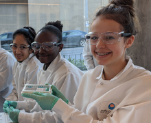 Students holding a 12-well strip of an ELISA