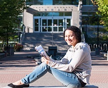 A girl sitting in front of a building