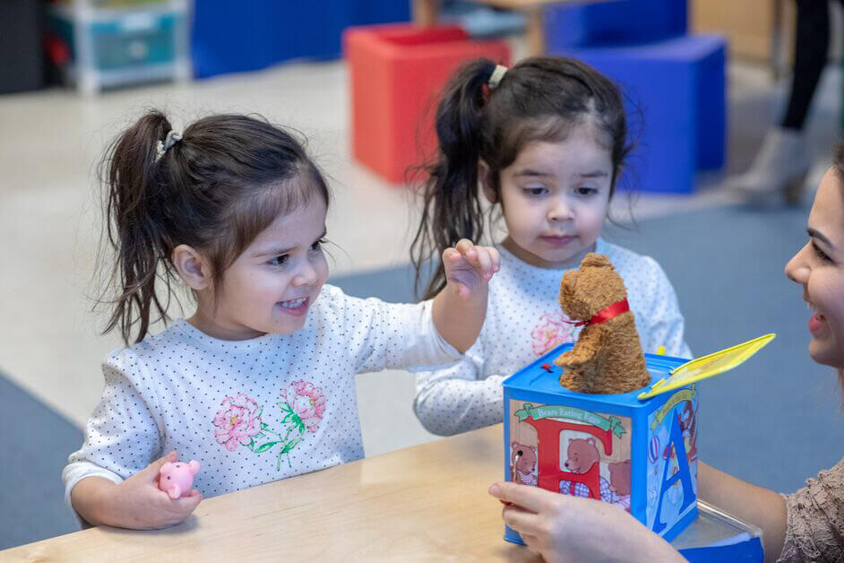 Children and adult playing with toy