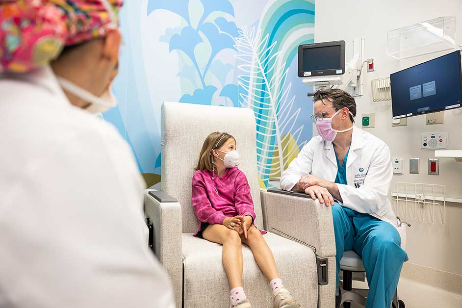 Dr. Brian Morray, director of Seattle Children’s Cardiac Catheterization Laboratories, confers with a cardiac patient in one of Forest B’s new spaces.