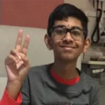 A boy giving a peace sign