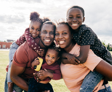 A family hugs outdoors