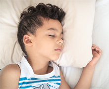 A boy sleeping on a bed