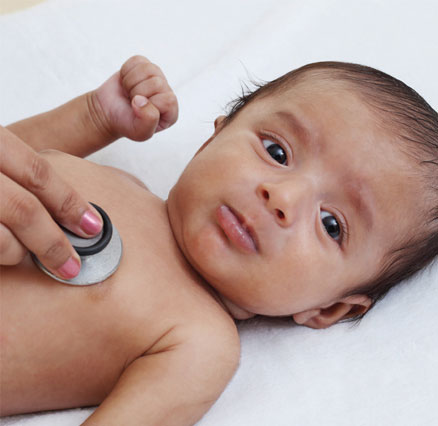 A baby is examined by a doctor